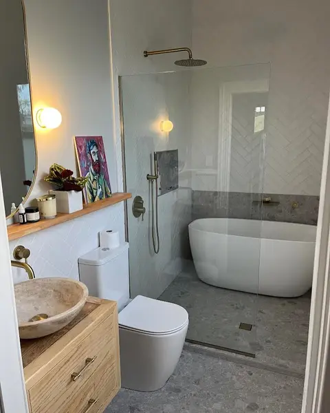 Freestanding bath, herringbone tile and brushed brass